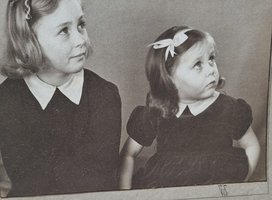 A black and white photo of two young girls