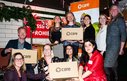 A group of CIUK staff pose with a CARE package at CARE's 80th anniversary event