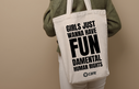 A person carrying a tote bag with the slogan 'Girls just wanna have FUNdamental human rights' plus the CARE logo