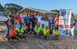 CARE Shelter team in front of a project in Mozambique