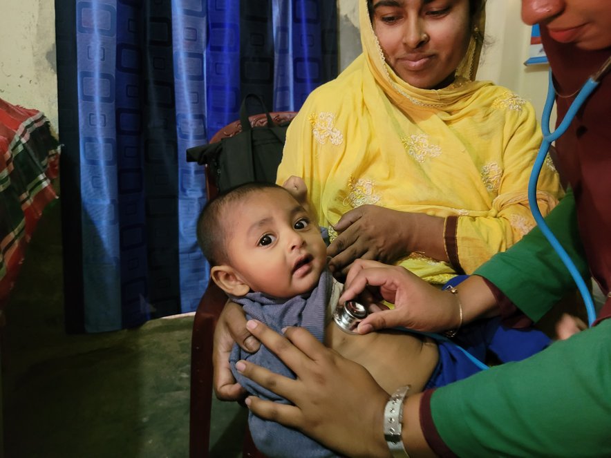 Asma with son Araf in health clinic