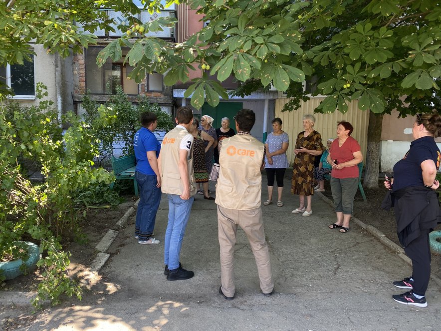 CARE staff talk to residents affected by the dam explosion in Ukraine