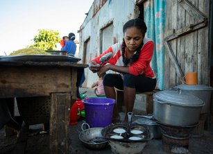 A woman cooking in a makeshift street kitchen