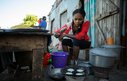 A woman cooking in a makeshift street kitchen