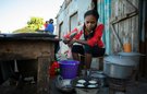 A woman cooking in a makeshift street kitchen