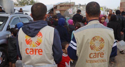 CARE and partner staff distribute water to people in displacement shelters in Rafah, Gaza