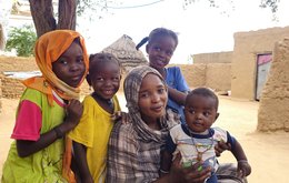 A woman with four young children in a refugee camp