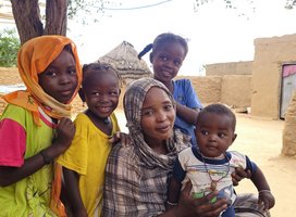 A woman with four young children in a refugee camp