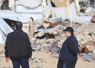Jolien and an aid worker survey destroyed buildings in Gaza