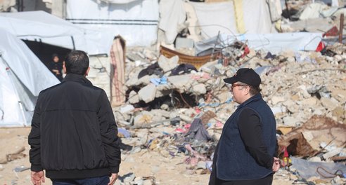 Jolien and an aid worker survey destroyed buildings in Gaza