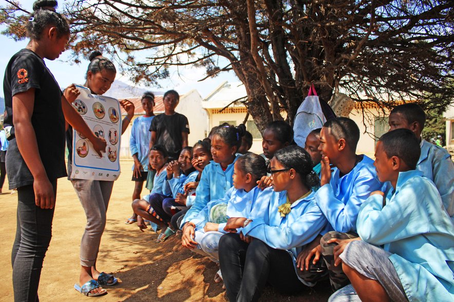 A group of schoolchildren are being shown diagrams of the reproductive system