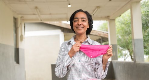 A woman holds some some reusable period pants