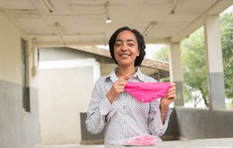 A woman holds some some reusable period pants