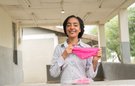 A woman holds some some reusable period pants
