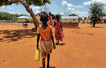 Girl walking away from camera carrying water bottle