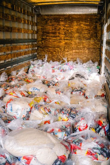 The inside of a truck containing bundles of emergency food supplies