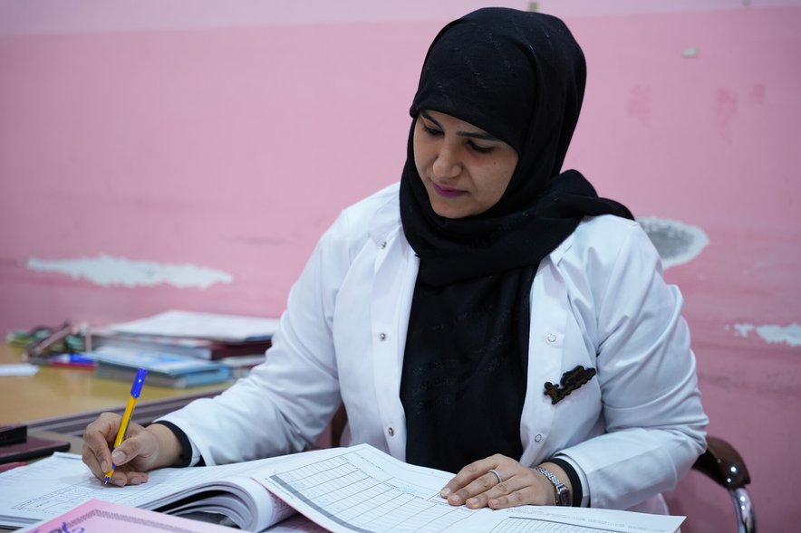 A healthcare worker at a desk