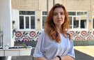 A woman stands in a school playground