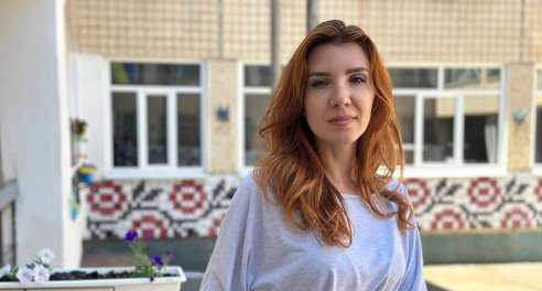 A woman stands in a school playground