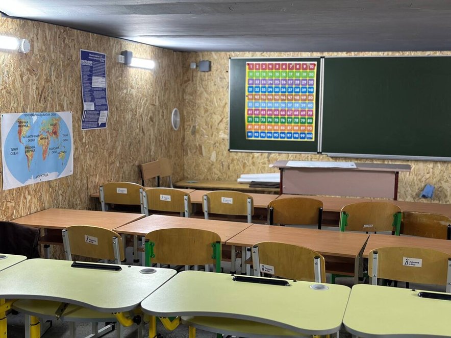 An empty classroom - construction looks temporary and walls are made of chipboard