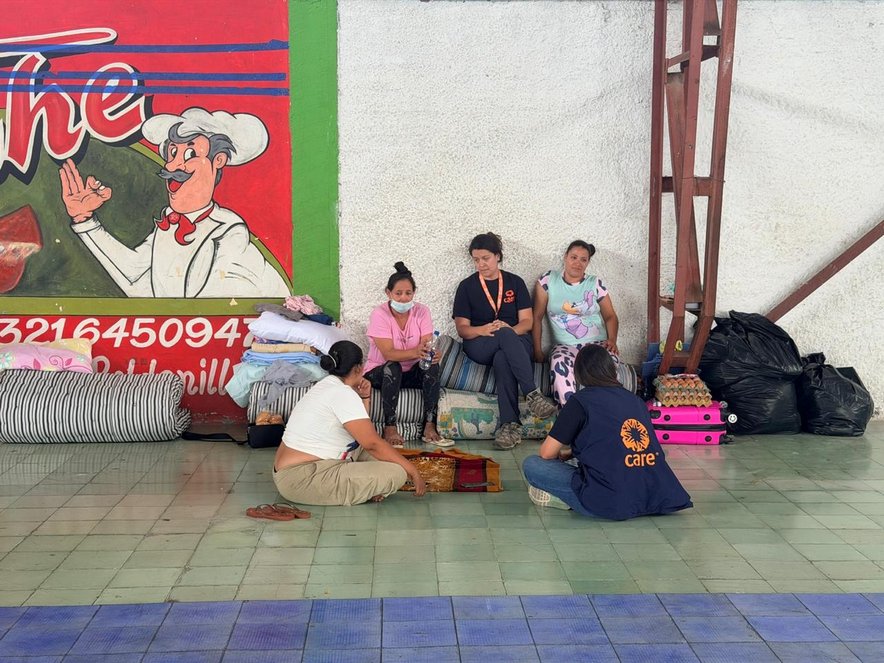 CARE staff sit with displaced women in a temporary shelter following the earthquake in western Colombia