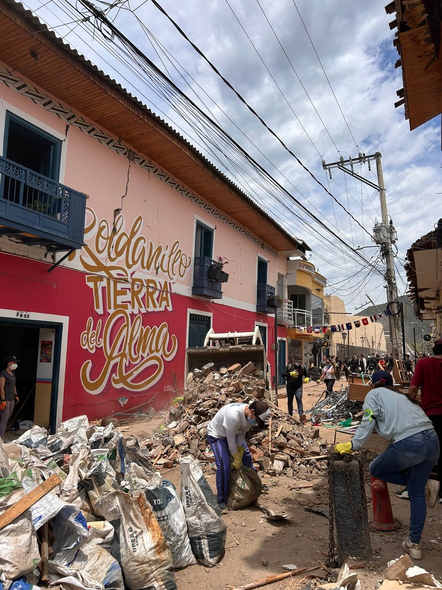 Community members clear through rubbles following the earthquake in western Colombia