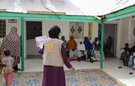 Women and children wait to be seen at a health facility in Somalia