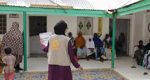 Women and children wait to be seen at a health facility in Somalia
