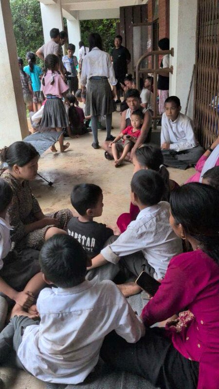 Displaced families shelter together in a temporary settlement