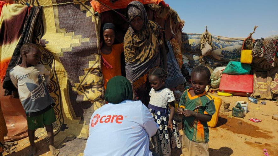 A CARE community health worker checks children for malnutrition in an IDP camp in Somalia