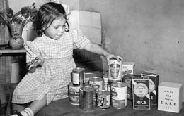 Frances Mason, aged 4, receiving the 10,000th CARE package from the US