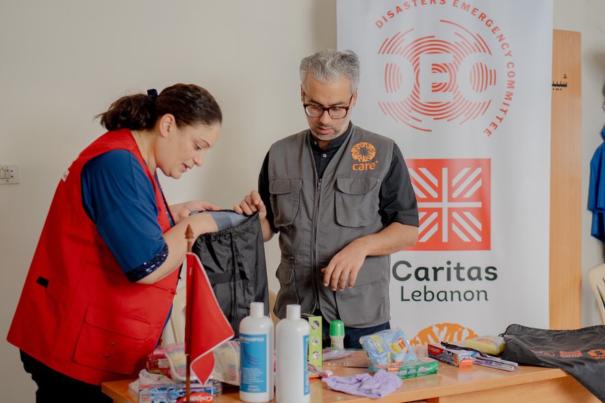 A man and a woman pack emergency hygiene supplies