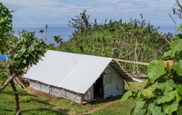 An image of a home build from metal slates in the tropics near the sea