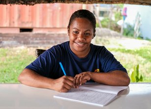 A woman making notes at a desk