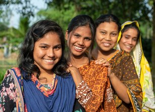Group of four young women smiling