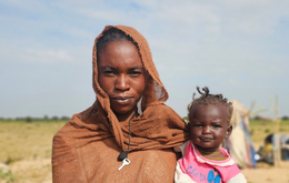 A woman holding a small child