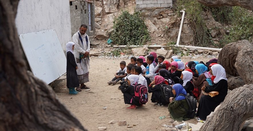 Young students study under trees in Abyan Governorate