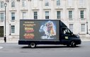 A truck drives in front of a UK parliamentary building with the slogan 'Dear Prime Minister, Back to the Future is a film, not foeign policy Reverse the Rollback. don't take women's rights back by decades. Protect funding for women and girls.