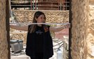 A woman measuring a doorway with a tape measure