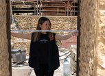 A woman measuring a doorway with a tape measure